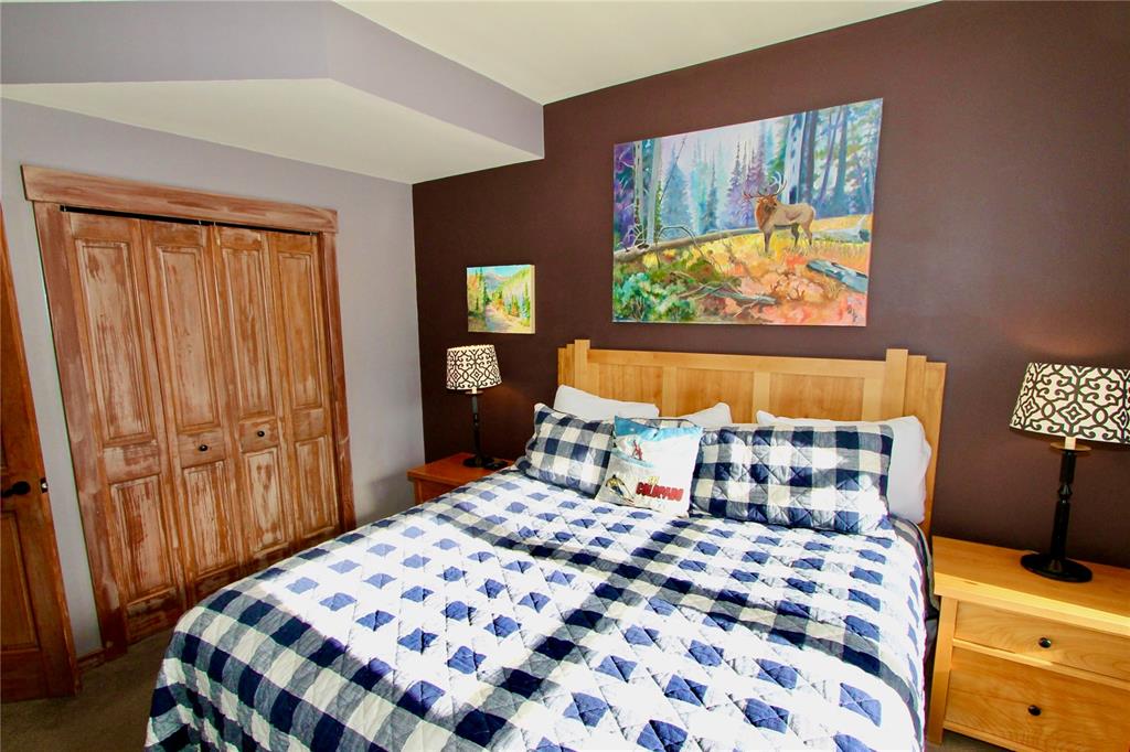 184 Copper Circle, Unit 524 Copper Mountain, CO 80443 - Photo 13 of 19 a bedroom with a bed and wooden floor