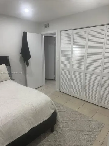 a bedroom with a bed and a walk in closet