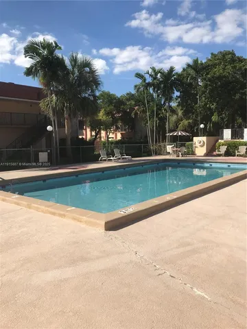 a view of a swimming pool and a yard