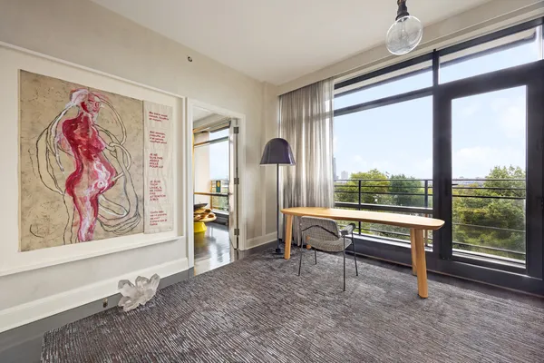 a living room with furniture stove and wooden floor