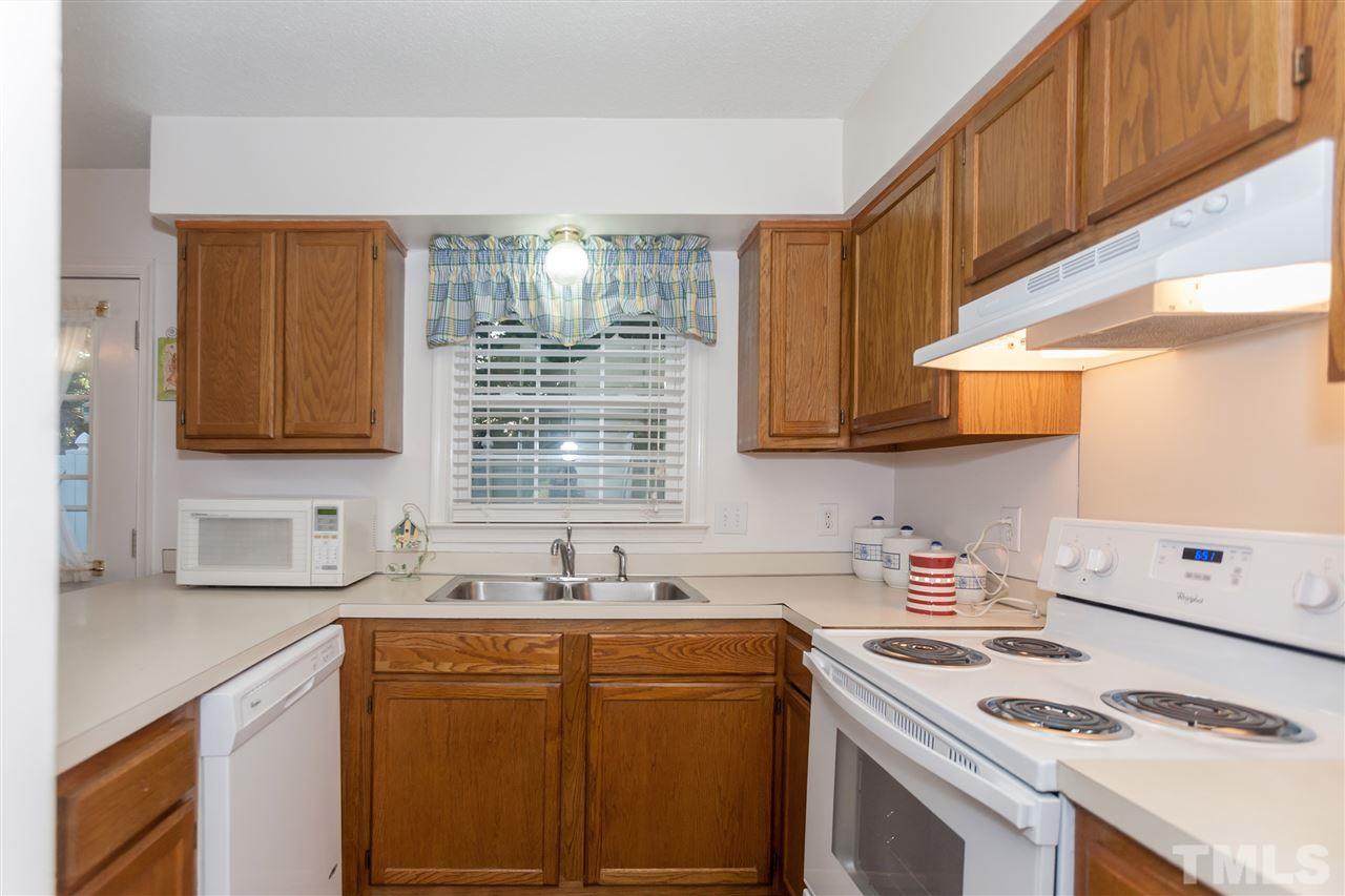 2959 Faversham Place Raleigh, NC 27604 - Photo 12 of 23 a kitchen with stainless steel appliances cabinets a sink and a window