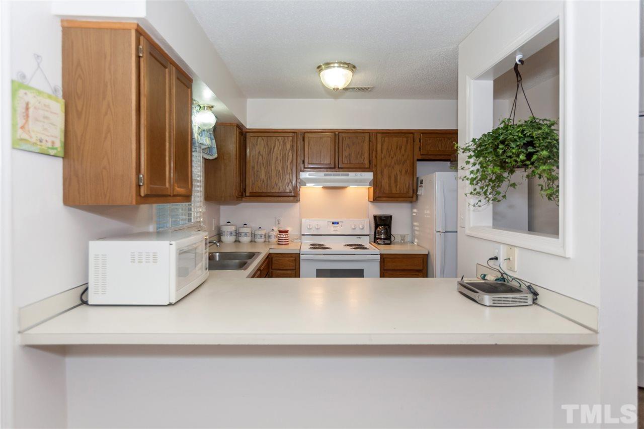 2959 Faversham Place Raleigh, NC 27604 - Photo 13 of 23 a kitchen with a sink a stove and a refrigerator