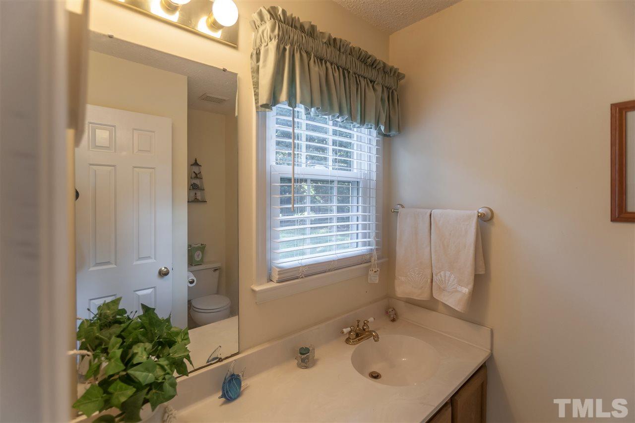 2959 Faversham Place Raleigh, NC 27604 - Photo 14 of 23 a bathroom with a sink and a mirror