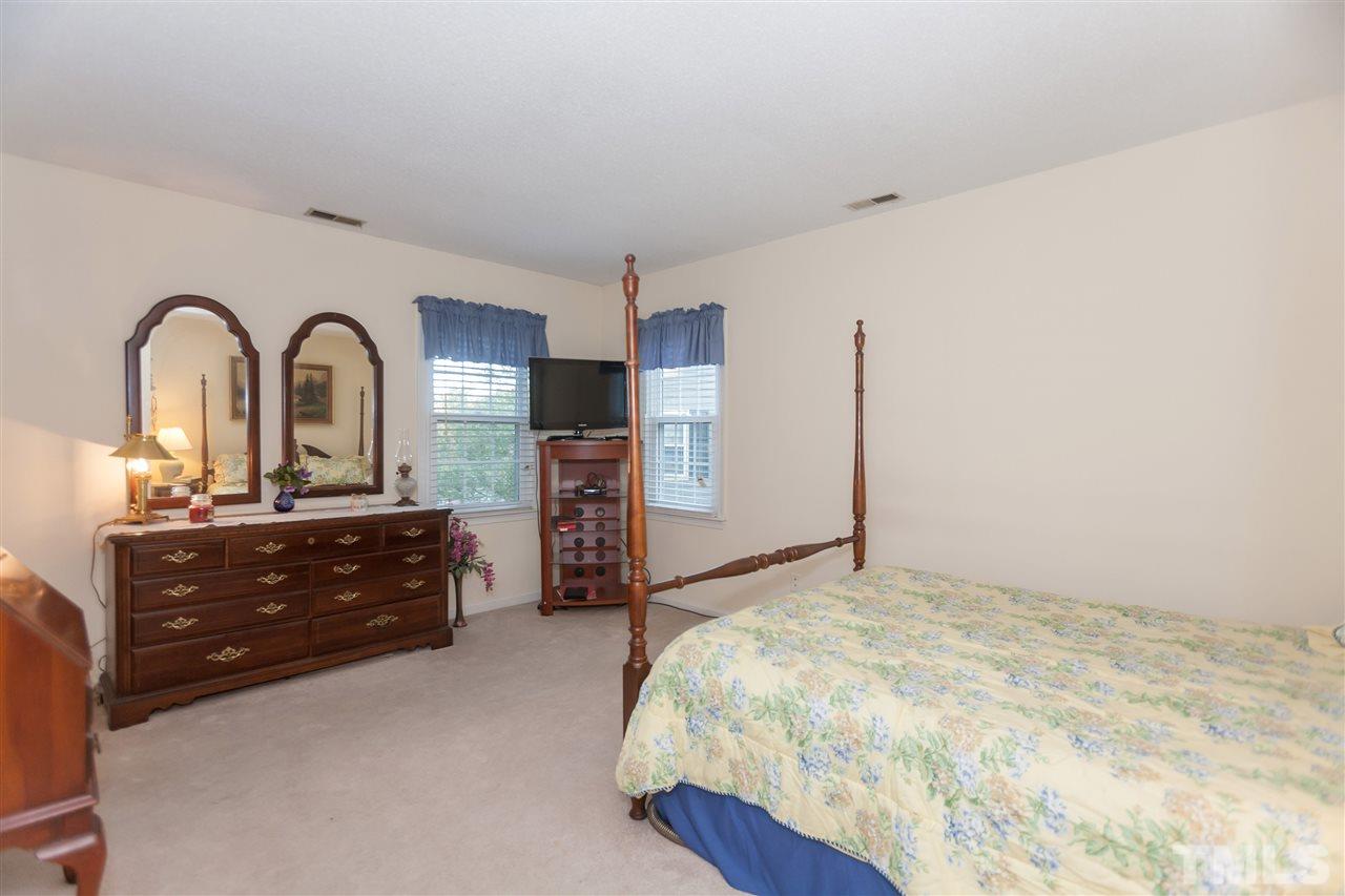 2959 Faversham Place Raleigh, NC 27604 - Photo 15 of 23 a bed room with a bed and a dresser