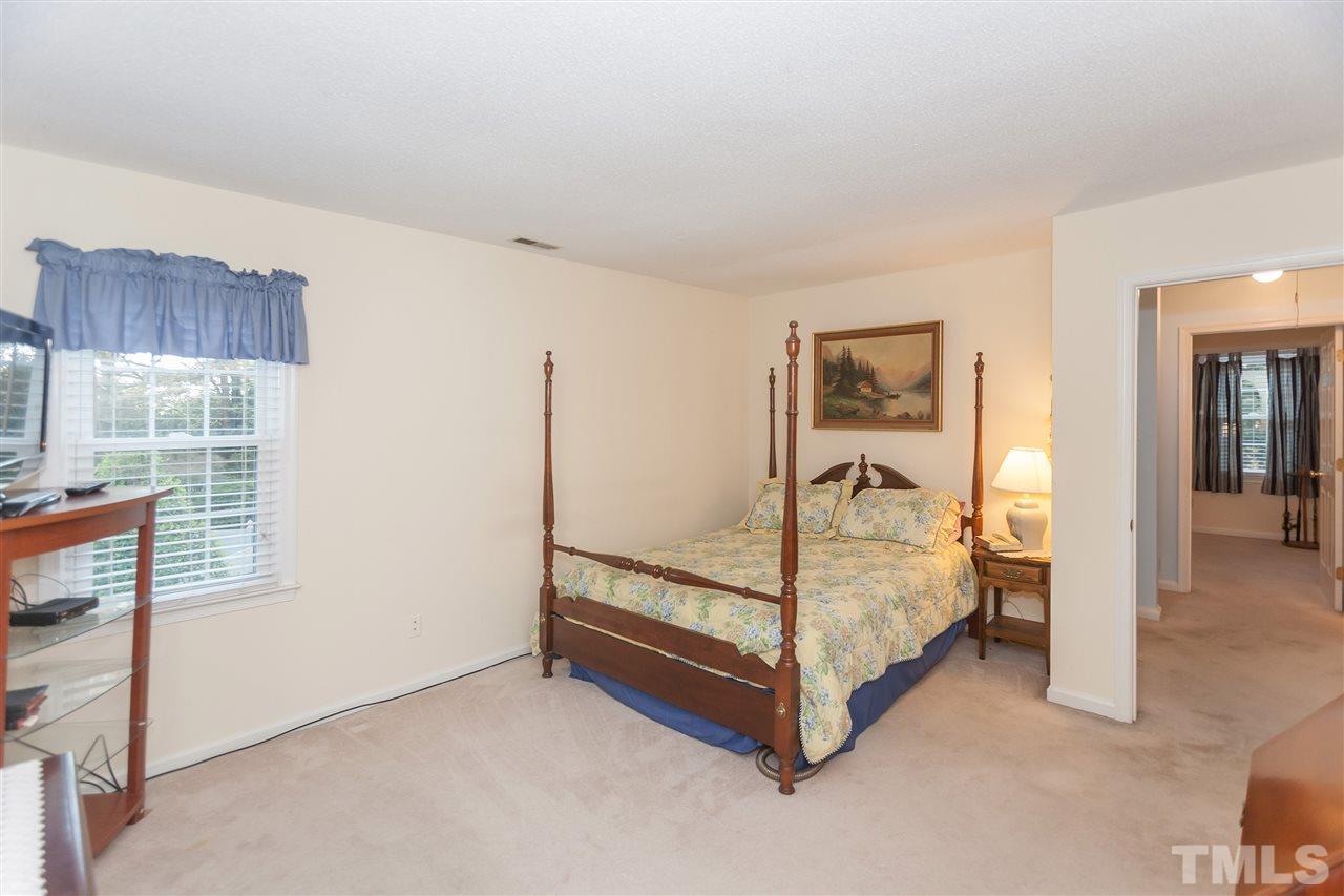 2959 Faversham Place Raleigh, NC 27604 - Photo 16 of 23 a bed room with a bed and a window