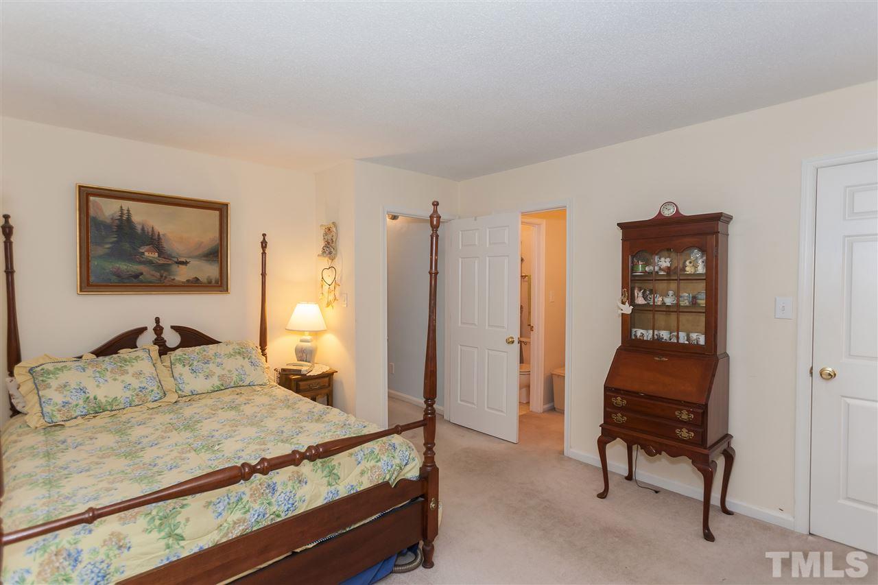 2959 Faversham Place Raleigh, NC 27604 - Photo 17 of 23 a bedroom with a bed and a dresser in it