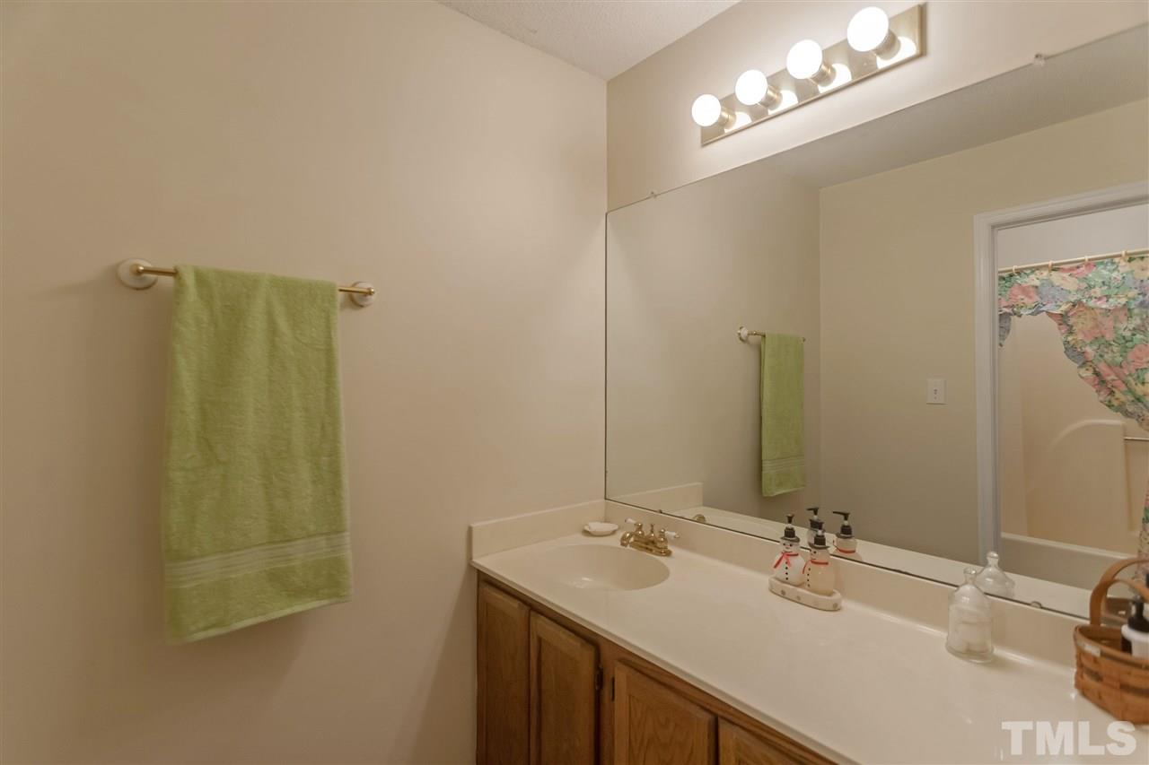 2959 Faversham Place Raleigh, NC 27604 - Photo 18 of 23 a bathroom with a sink vanity granite and a mirror