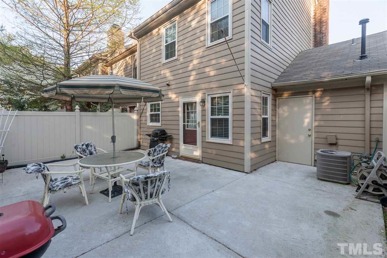 2959 Faversham Place Raleigh, NC 27604 - Photo 21 of 23 a view of a patio with table and chairs under an umbrella
