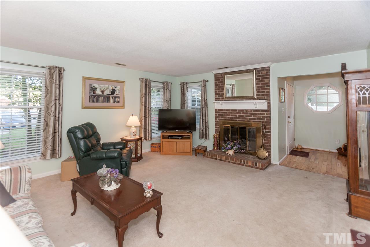 2959 Faversham Place Raleigh, NC 27604 - Photo 6 of 23 a living room with furniture and a fireplace