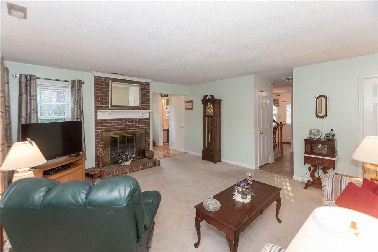 2959 Faversham Place Raleigh, NC 27604 - Photo 7 of 23 a living room with furniture and a fireplace