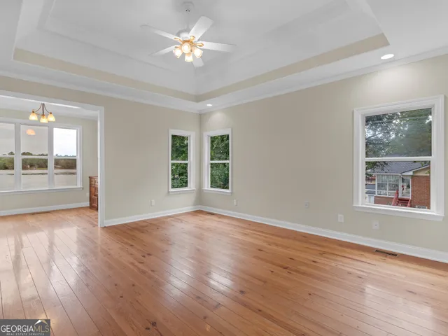 a view of an empty room and wooden floor