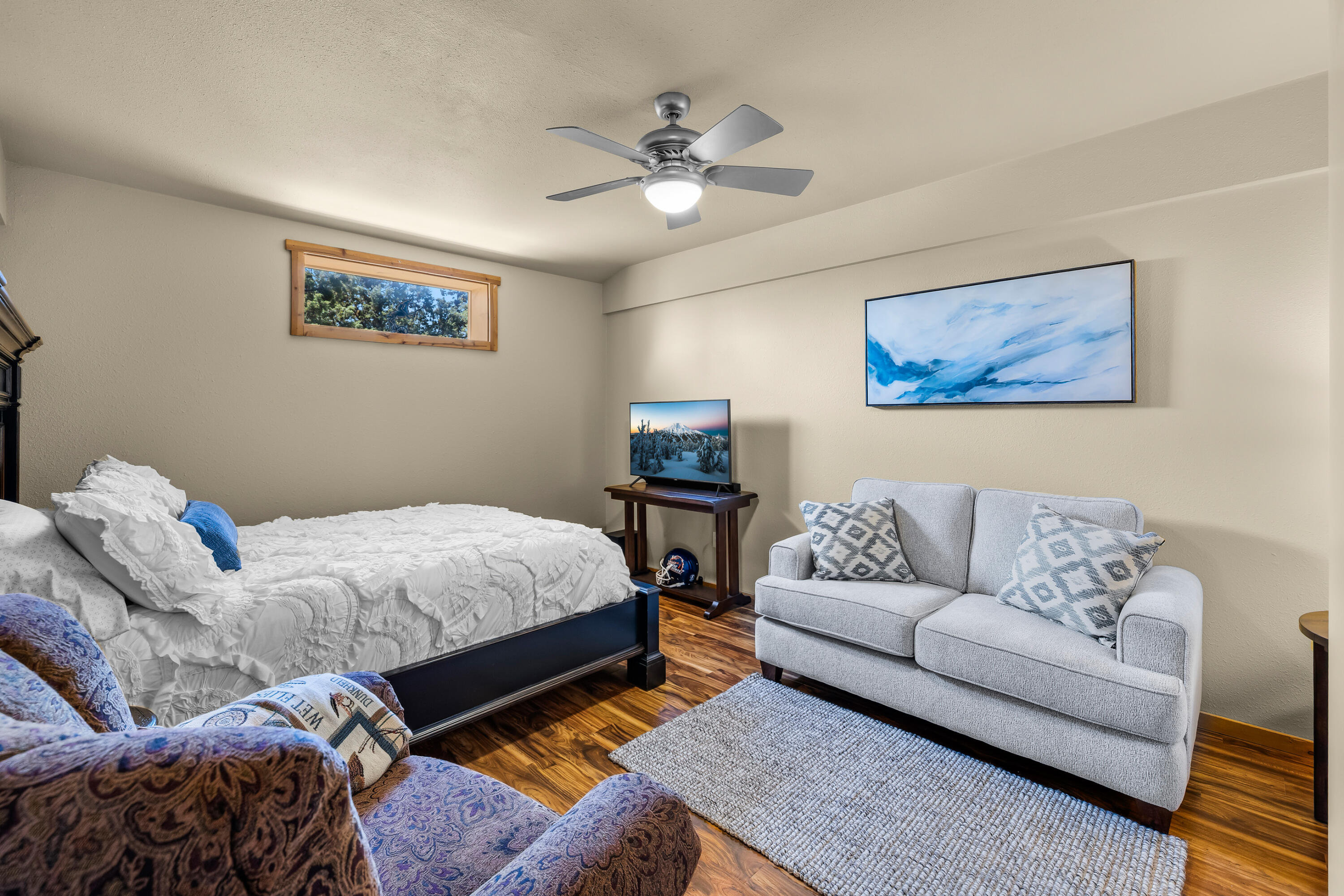 64145 Hunnell Road Bend, OR 97703 - Photo 62 of 65 One of three separate rooms within the upper-level guest/flex quarters is currently arranged as a guest space, offering comfortable flexibility for overnight visitors, extended stays, office use or hobbies.