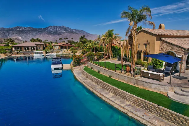 a view of a house with swimming pool and a yard