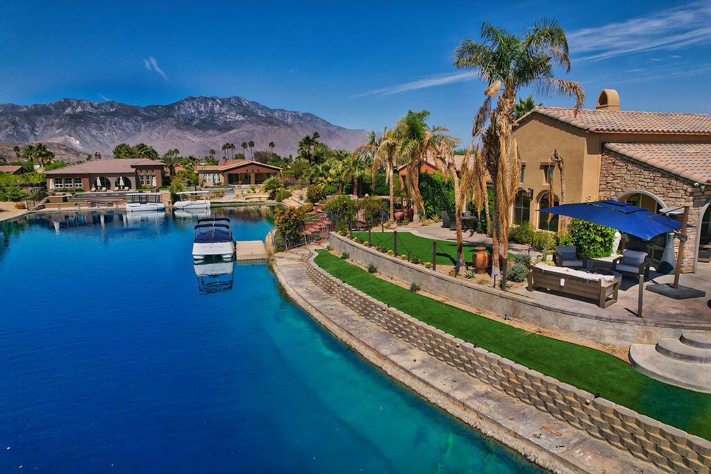 a view of a house with swimming pool and a yard