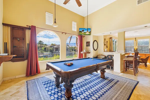 a living room with rug pool table and a table
