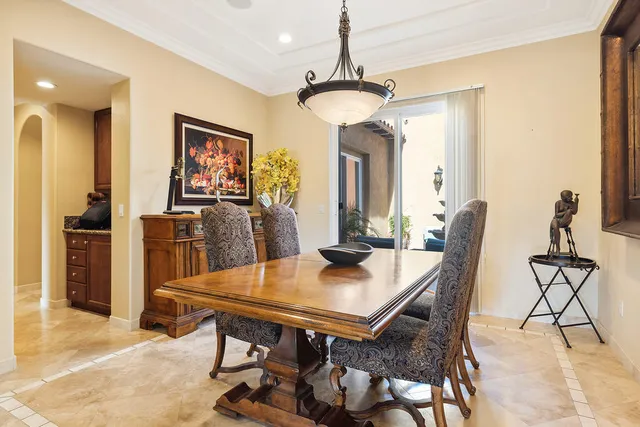 a view of a dining room with furniture and a chandelier