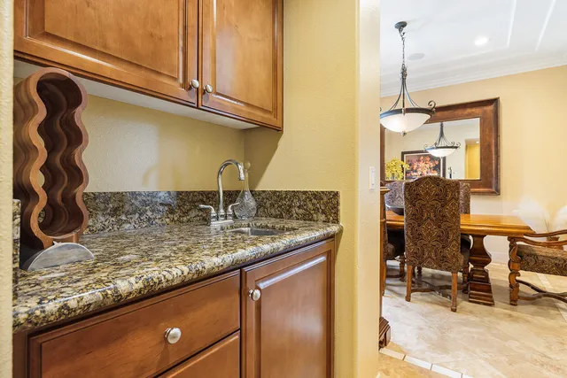 a view of a kitchen with granite countertop a sink and a wooden floor