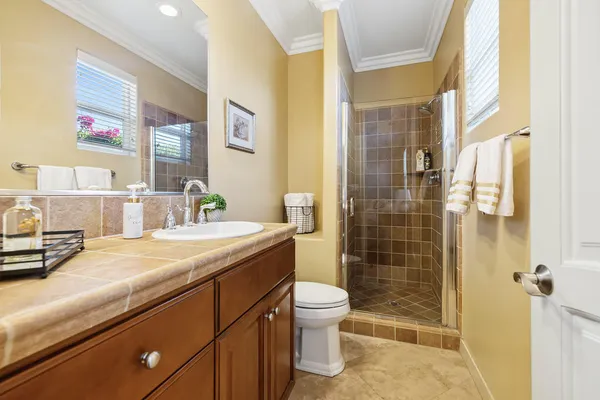 a bathroom with a sink a toilet and shower