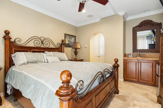 a bedroom with a bed and a chandelier