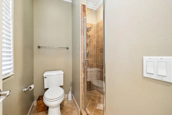a white toilet sitting next to a bathroom sink