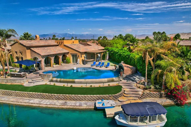 a view of a house with a yard and table