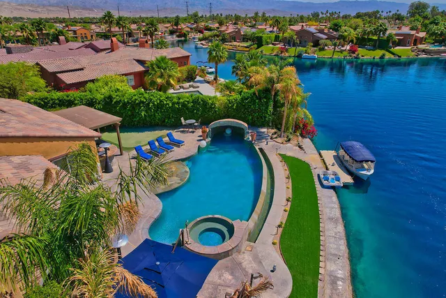 an aerial view of a house with outdoor space and a lake view