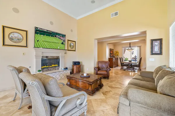 a living room with furniture a flat screen tv and a fireplace