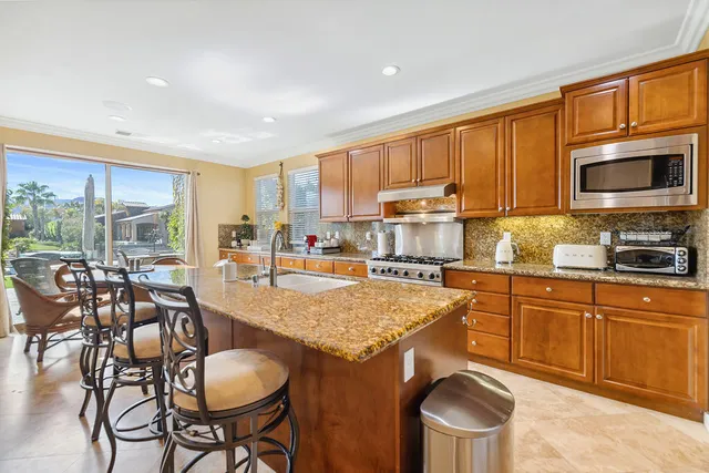 a kitchen with a stove a table and chairs