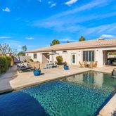 a view of a house with swimming pool and sitting area