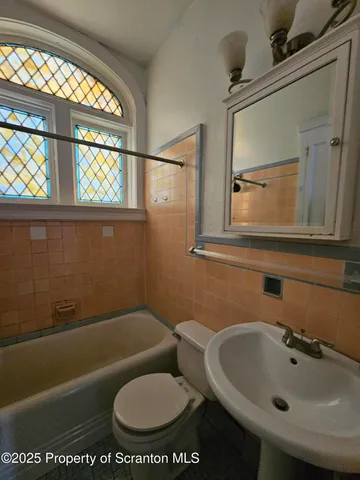 a bathroom with a toilet and a sink