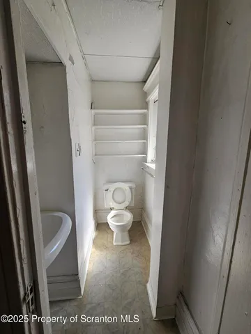 a bathroom with a toilet and a sink