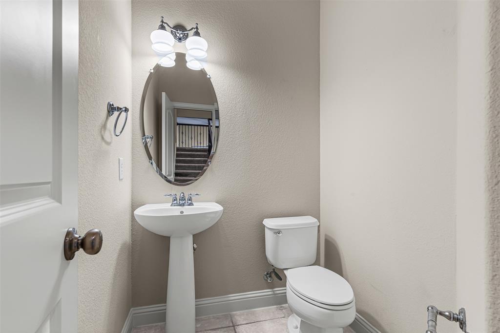 5717 Lunsford Road Plano, TX 75024 - Photo 11 of 25 a bathroom with a toilet sink and mirror