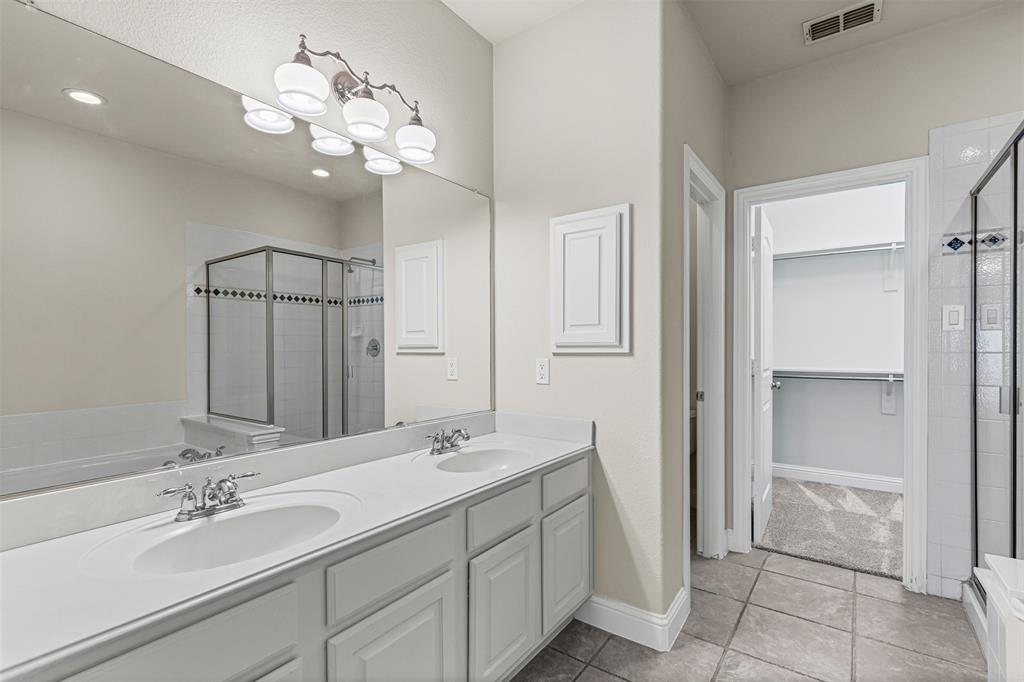 5717 Lunsford Road Plano, TX 75024 - Photo 14 of 25 a bathroom with a double vanity sink and a mirror