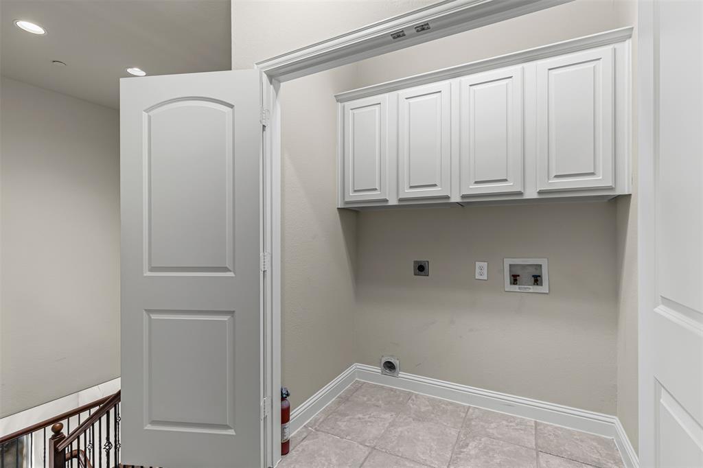 5717 Lunsford Road Plano, TX 75024 - Photo 22 of 25 a view of storage and utility room with empty racks