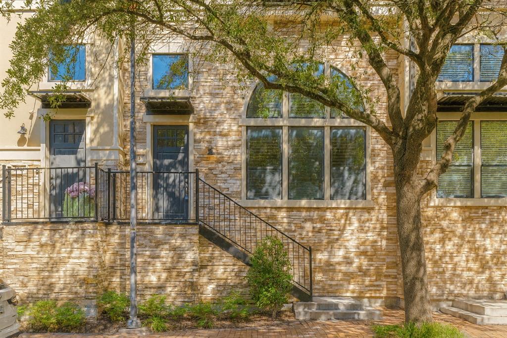 5717 Lunsford Road Plano, TX 75024 - Photo 25 of 25 a view of a brick house with large windows and a tree
