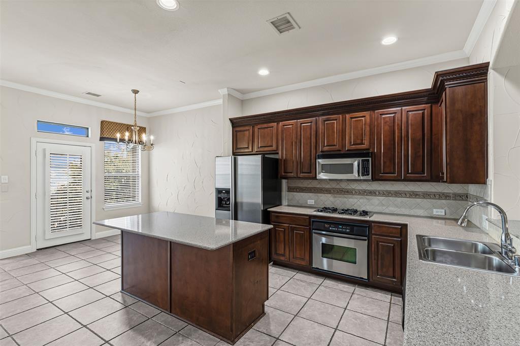 5717 Lunsford Road Plano, TX 75024 - Photo 5 of 25 a kitchen with stainless steel appliances granite countertop a stove a sink dishwasher a refrigerator and a oven with wooden floor