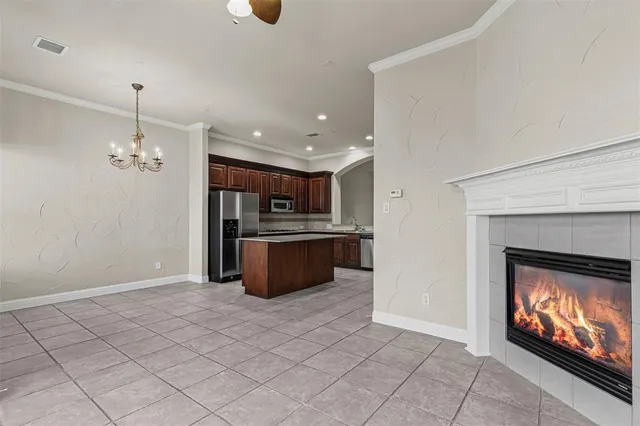 a view of kitchen with fireplace and cabinets
