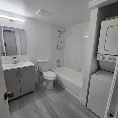 a bathroom with a toilet a sink and bathtub