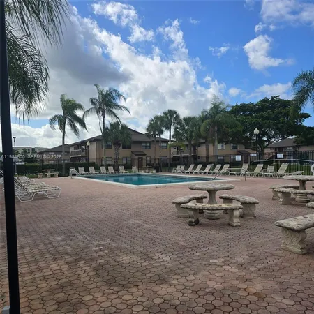 a swimming pool with outdoor seating and city view