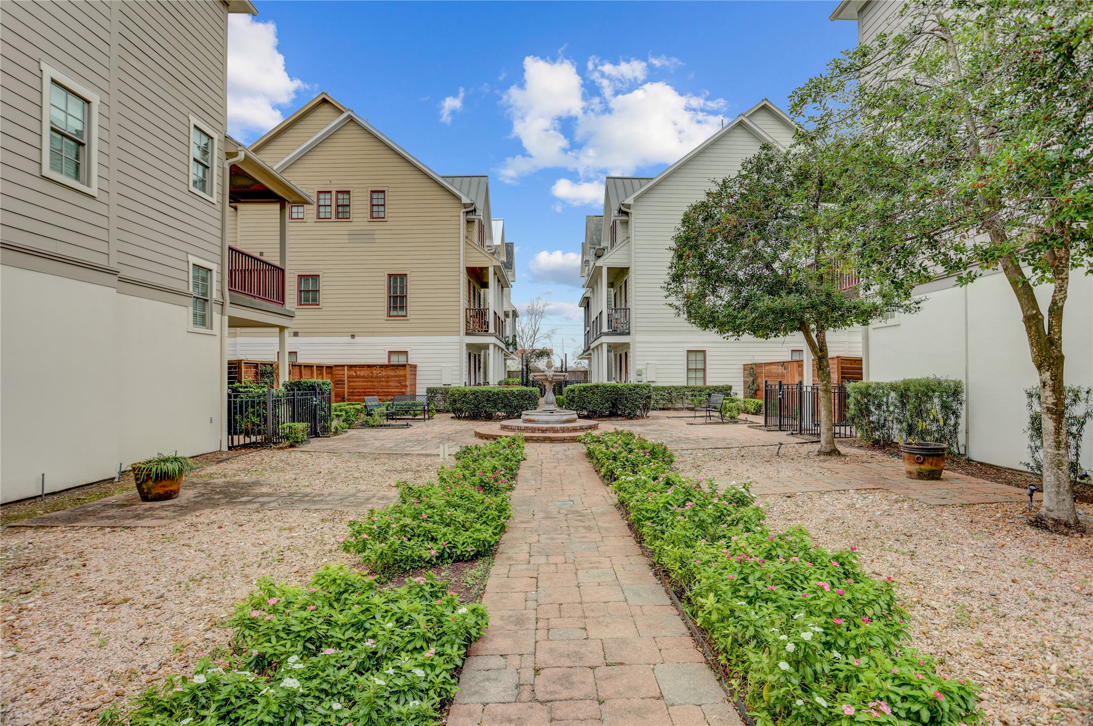 3225 Maxroy Street Houston, TX 77008 - Photo 25 of 30 Views of the fountain and garden area, complete with benches, offer a serene spot for relaxing.