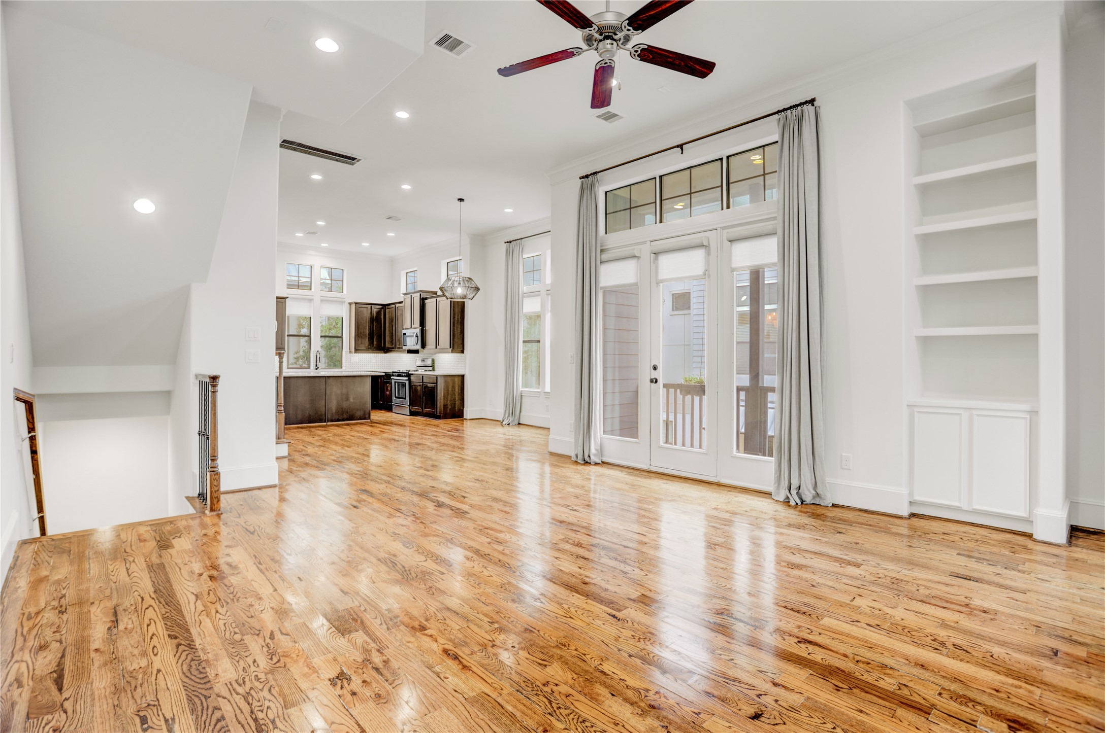 3225 Maxroy Street Houston, TX 77008 - Photo 8 of 30 Real wood floors throughout, a private balcony just off the living room, and an open-concept layout connecting the living, dining, and kitchen spaces.