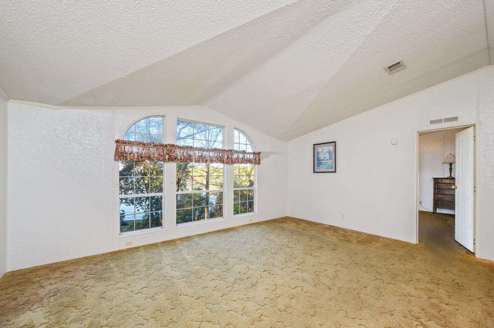 679 Squirrel Road DeFuniak Springs, FL 32433 - Photo 19 of 57 wooden floor in an empty room with a window