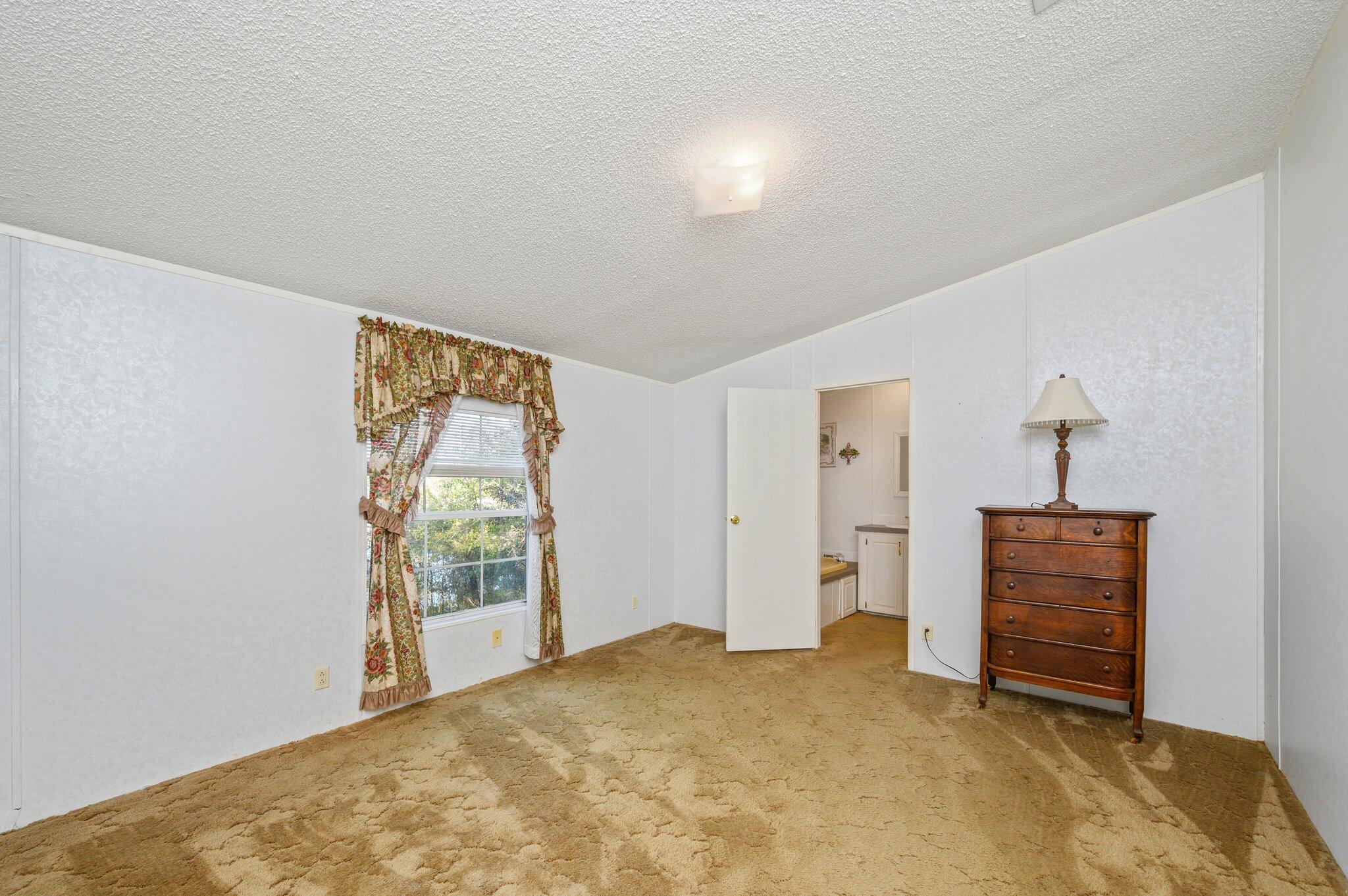 679 Squirrel Road DeFuniak Springs, FL 32433 - Photo 20 of 57 an empty room with closet and wooden floor