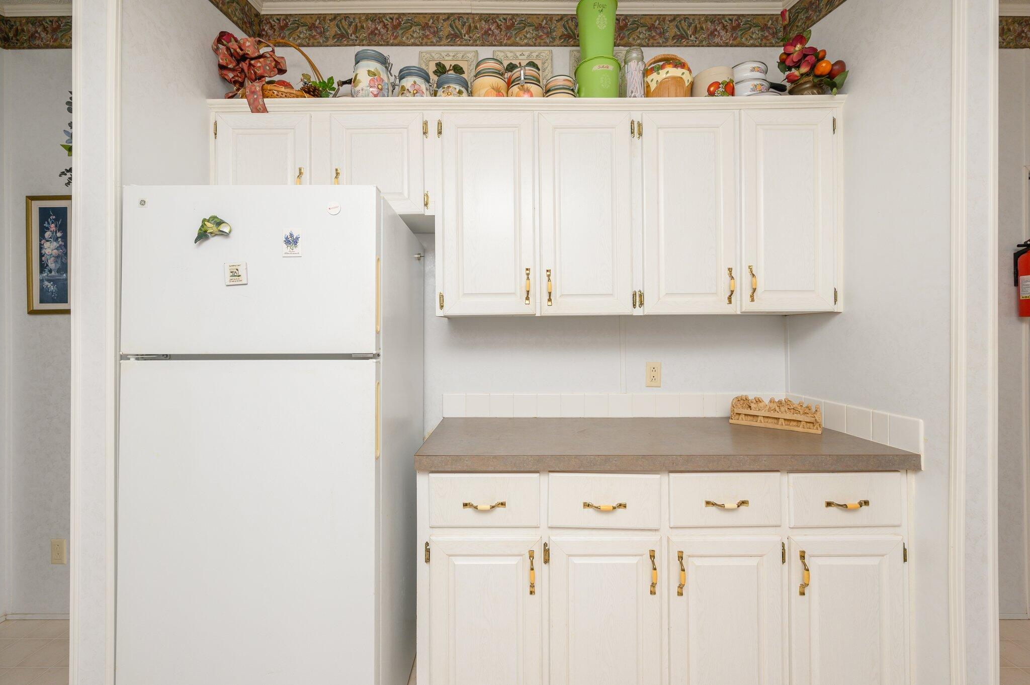 679 Squirrel Road DeFuniak Springs, FL 32433 - Photo 29 of 57 a white refrigerator freezer sitting inside of a kitchen