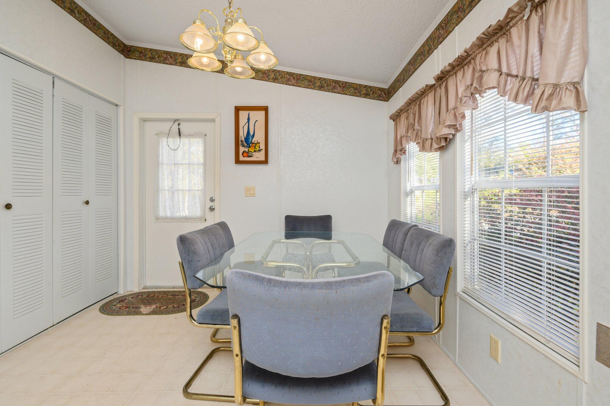 679 Squirrel Road DeFuniak Springs, FL 32433 - Photo 30 of 57 a view of a dining room with furniture and chandelier