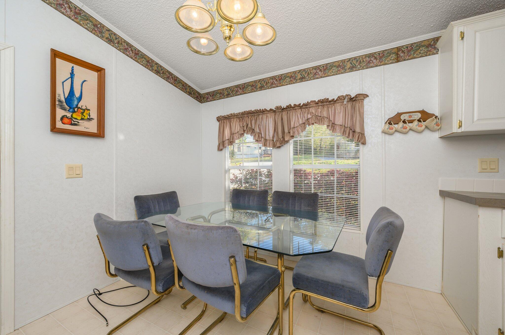 679 Squirrel Road DeFuniak Springs, FL 32433 - Photo 31 of 57 a view of a dining room with furniture and chandelier