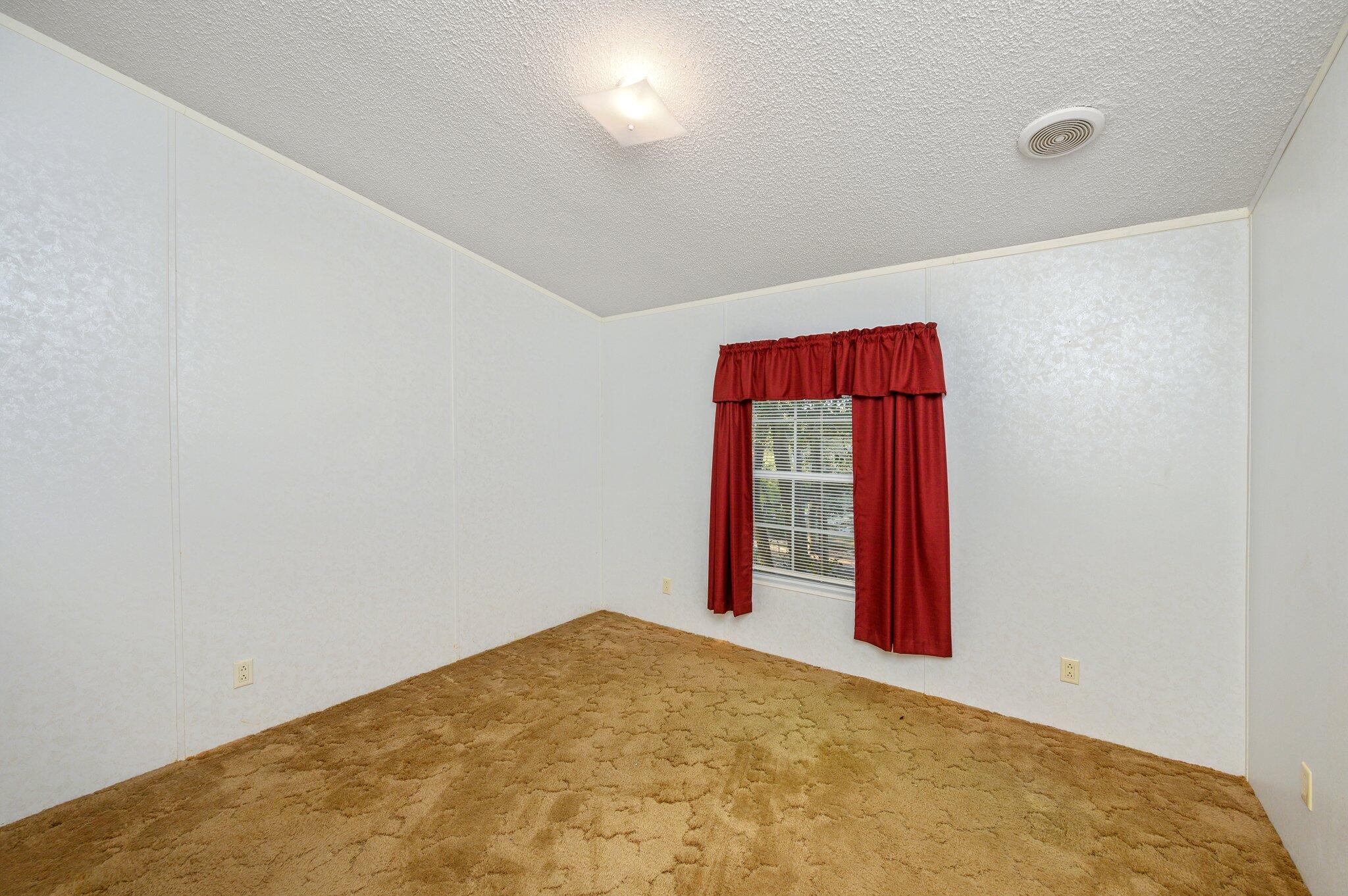 679 Squirrel Road DeFuniak Springs, FL 32433 - Photo 36 of 57 a view of a room with a window and carpet