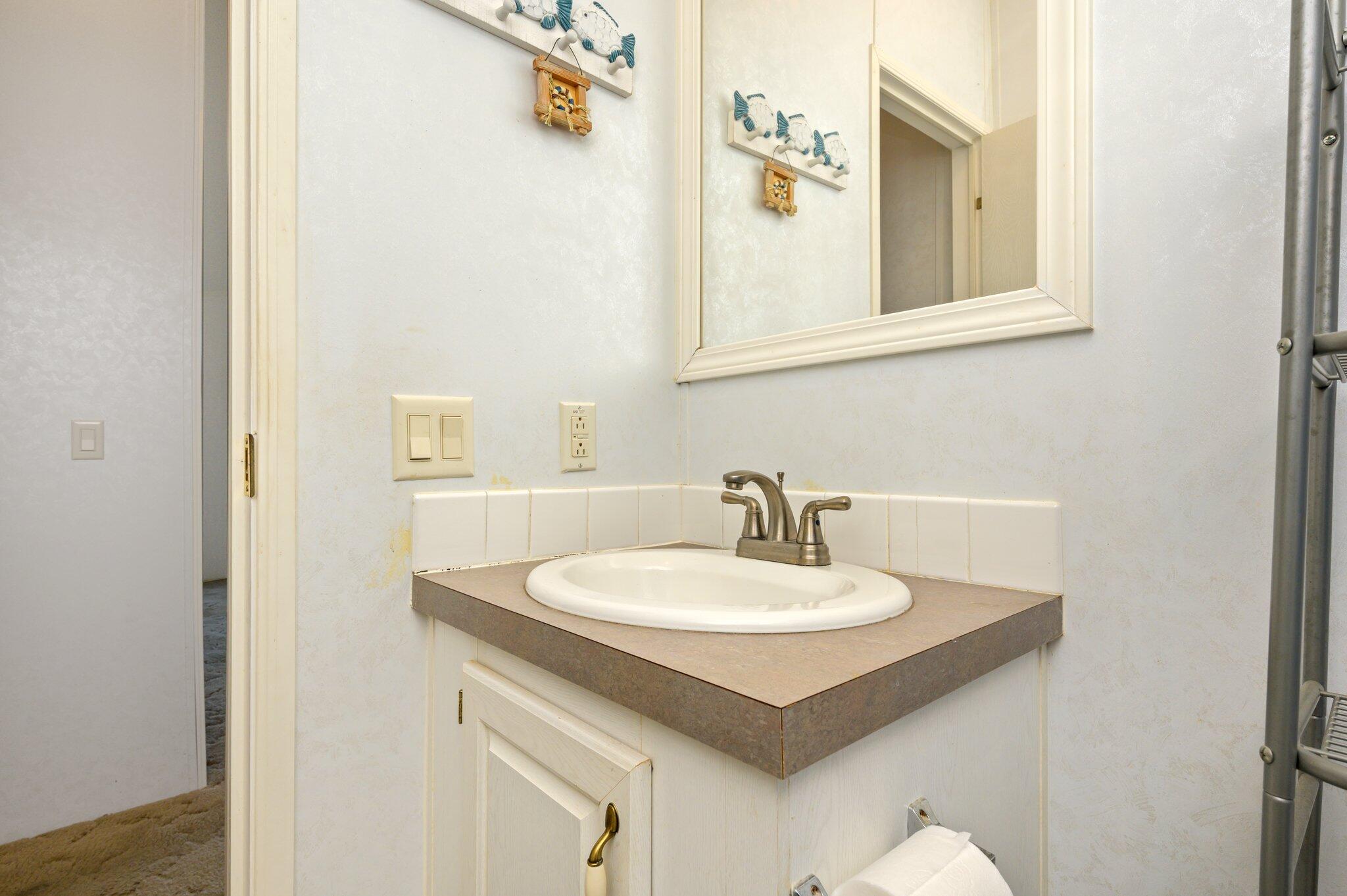 679 Squirrel Road DeFuniak Springs, FL 32433 - Photo 39 of 57 a bathroom with a sink and a mirror