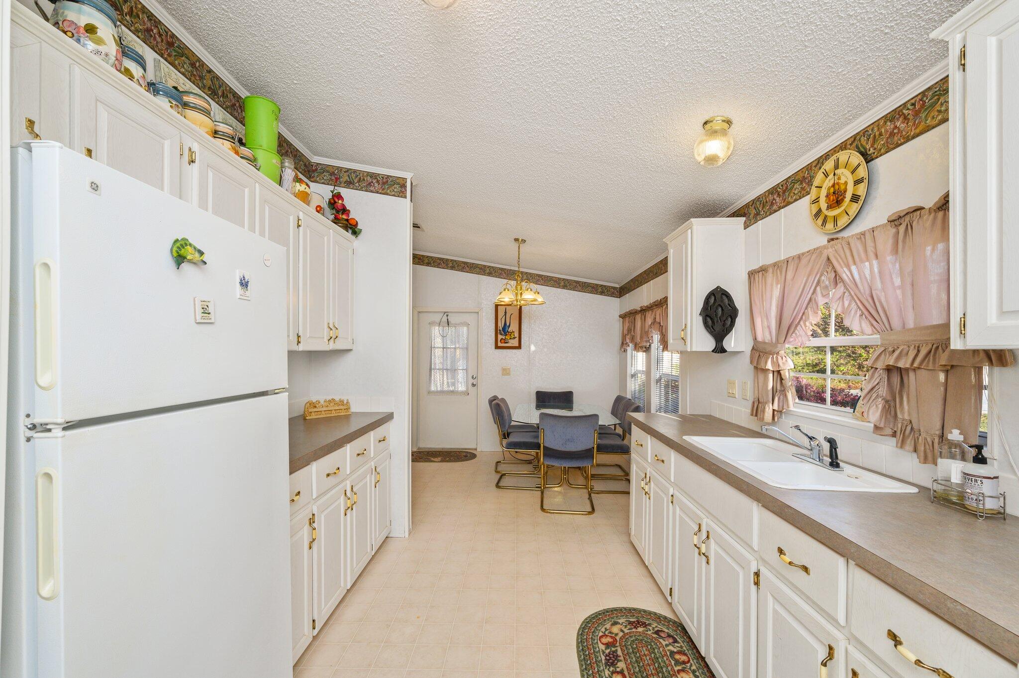 679 Squirrel Road DeFuniak Springs, FL 32433 - Photo 9 of 57 a kitchen with a refrigerator a sink and a stove