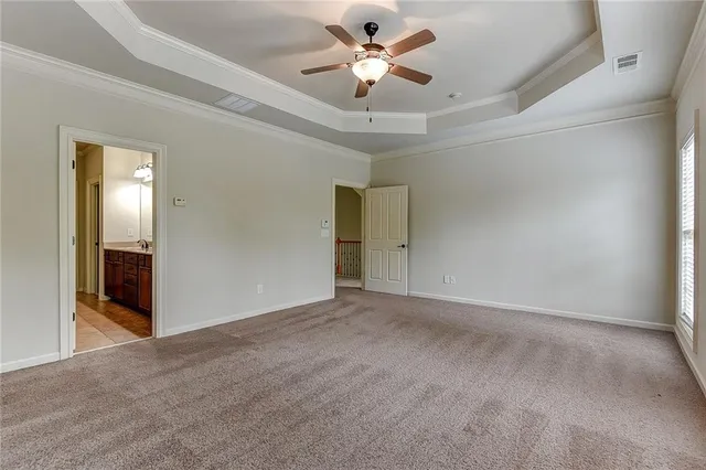 a view of an empty room and a ceiling fan